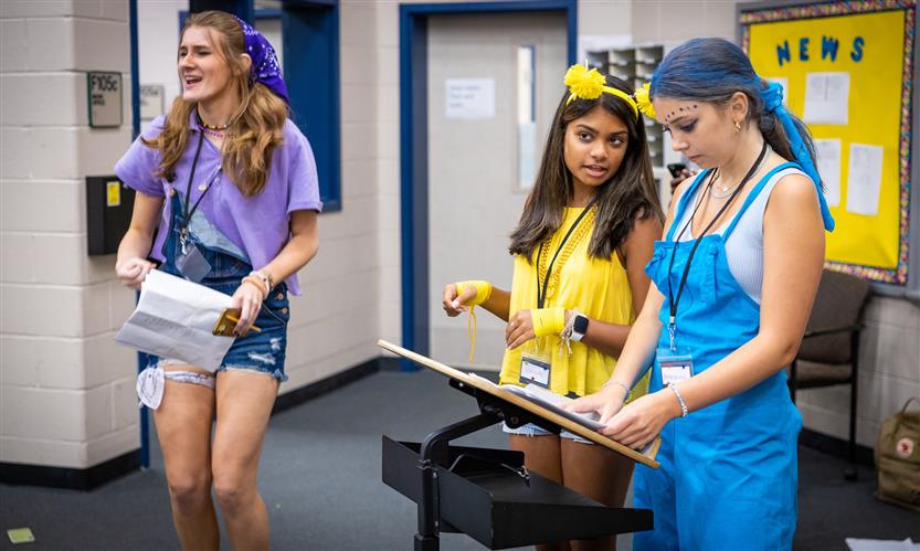 Camp counselors conduct singing students
